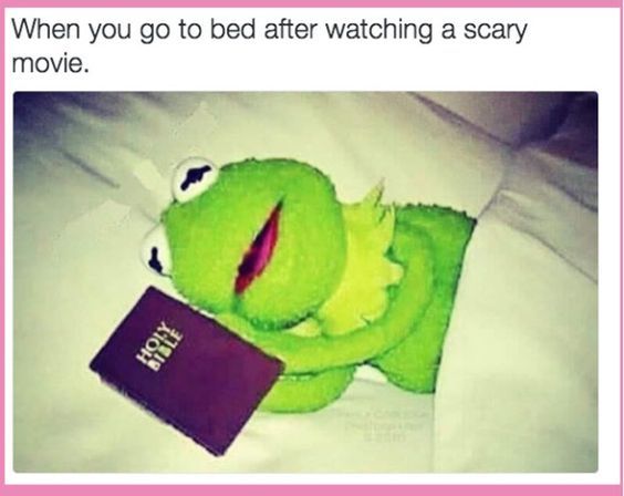 A picture of Kermit the frog lying in bed holding a Holy Bible. The text above reads: "When you go to bed after watching a scary movie."