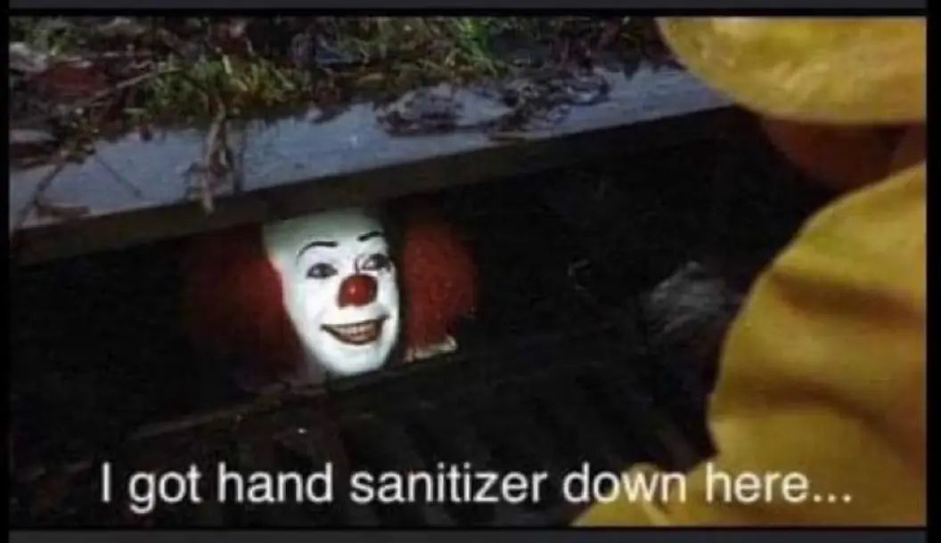 A clown with white face paint, a red nose, and red hair is in a sewer grate with the text 'I got hand sanitizer down here...'