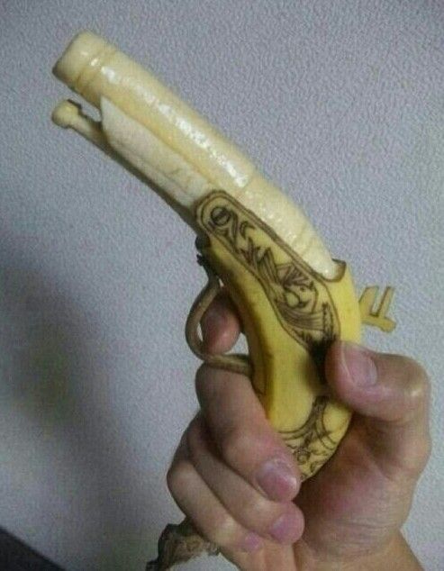 A banana is carved into the shape of a gun.