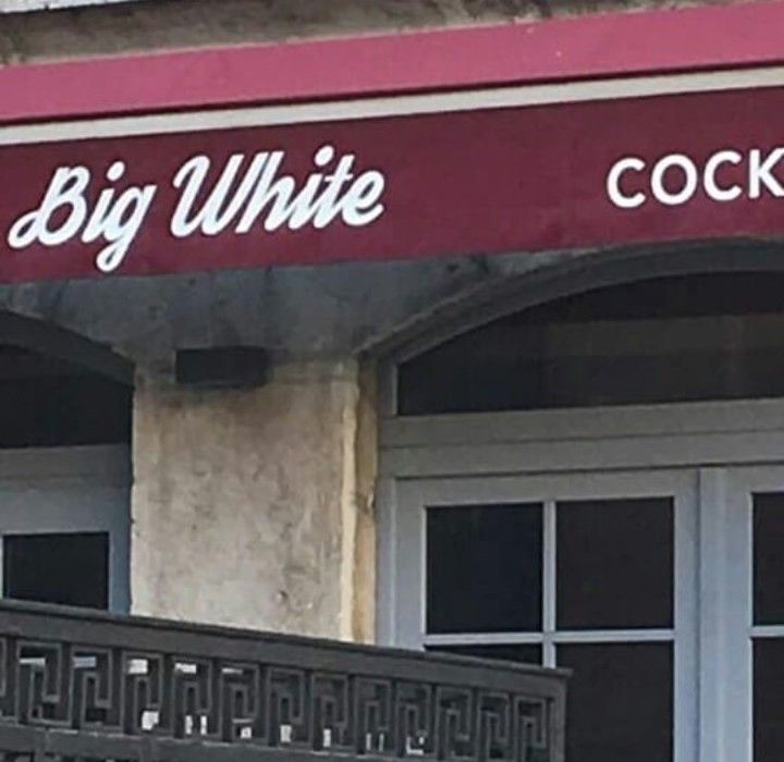 A sign for a bar or restaurant that says "Big White COCKTAILS".