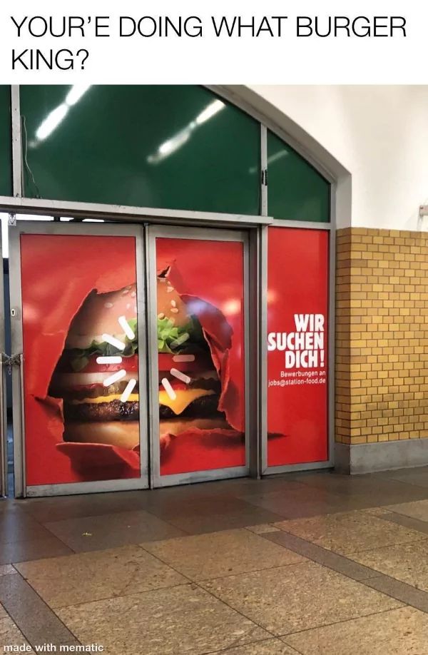 A Burger King advertisement is on a glass door that has a tear in the middle, revealing a burger. The text on the door says: "Wir suchen dich! Bewerbungen an jobs@station-food.de". Above the door is the question "YOUR'RE DOING WHAT BURGER KING?"