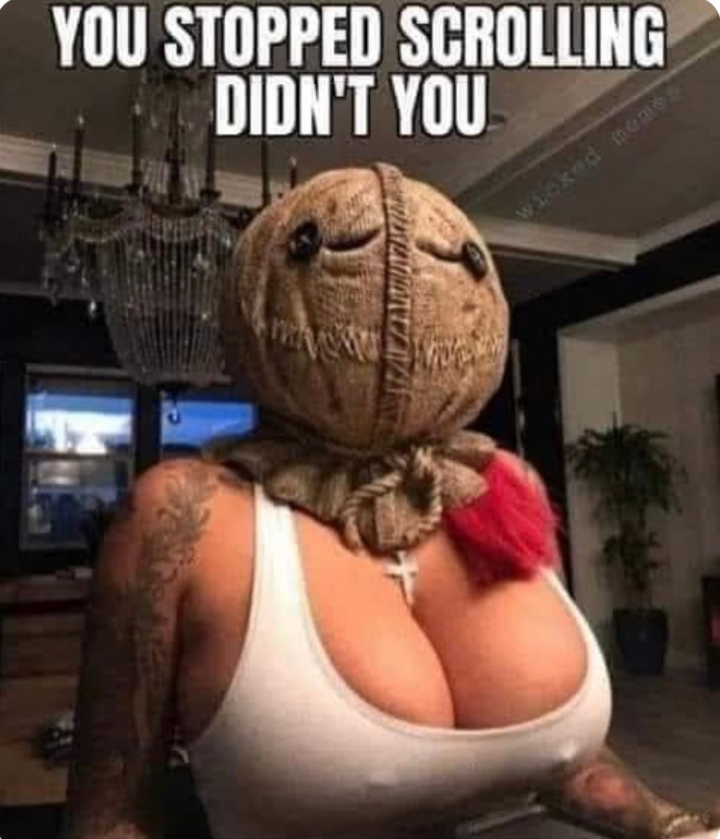 The image shows a woman with a scarecrow mask on her head and a white tank top. The text on the image says, "YOU STOPPED SCROLLING DIDN'T YOU."