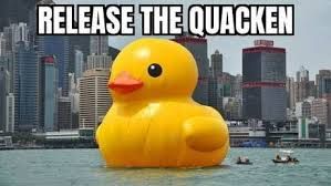 A large, yellow rubber duck floats on a body of water. In the background, there is a city skyline. The text "RELEASE THE QUACKEN" is overlaid on the image.