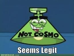 A green cartoon character with a lampshade shape and a wide smile. The text above says 'Not Cosmo', and the text below says 'Seems legit'.