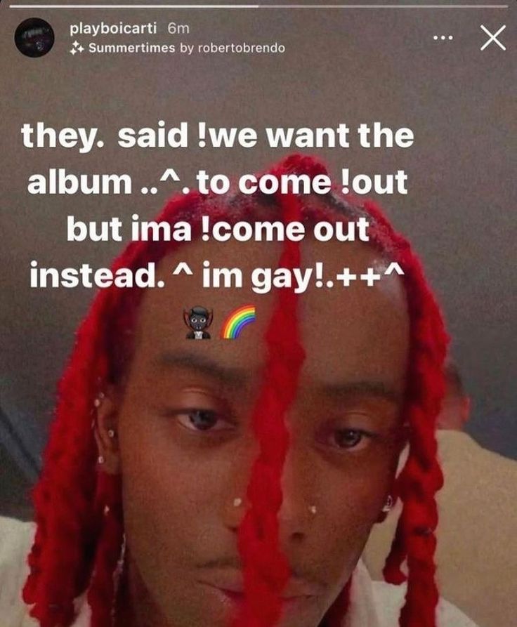 A selfie of Playboi Carti with red braided hair, a nose ring and several piercings. The text overlay reads: "they said! We want the album to come out but ima! come out instead. I'm gay!" There is a devil emoji with a rainbow after it.