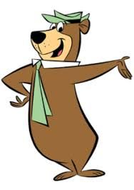 An illustration of Yogi Bear, a cartoon bear character, standing with his right arm extended, wearing a green hat and necktie. He's smiling and looking to the right.