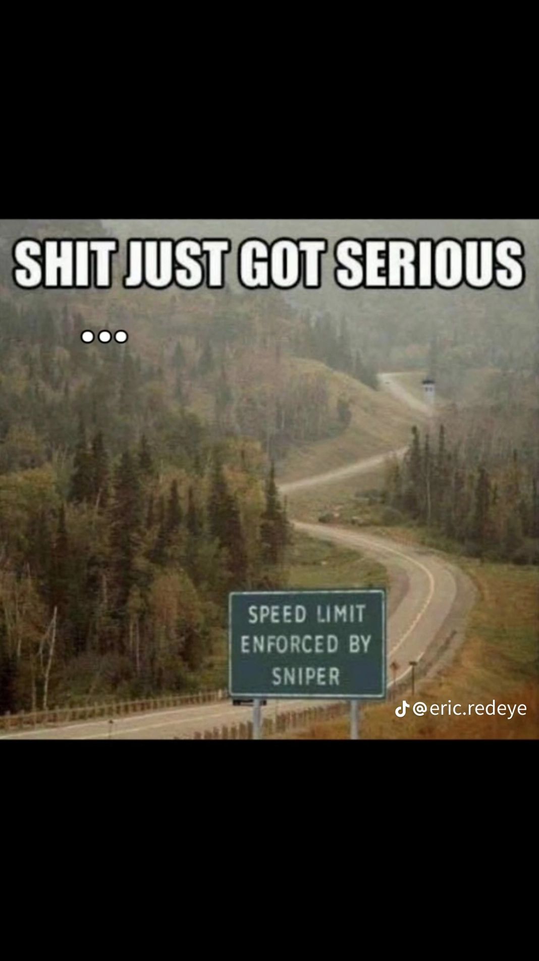 A road sign on a winding road in a mountainous landscape. The sign says "SPEED LIMIT ENFORCED BY SNIPER" and above the sign is the text "SHIT JUST GOT SERIOUS" with three dots below it. The lower right corner has a TikTok handle.