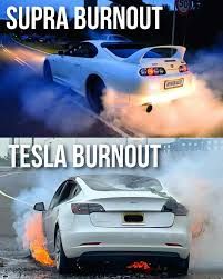 The image shows two pictures side-by-side. The top picture shows a white Supra doing a burnout with a lot of smoke. The text above says "SUPRA BURNOUT". The bottom picture shows a white Tesla doing a burnout with a lot of fire and smoke. The text above says "TESLA BURNOUT".