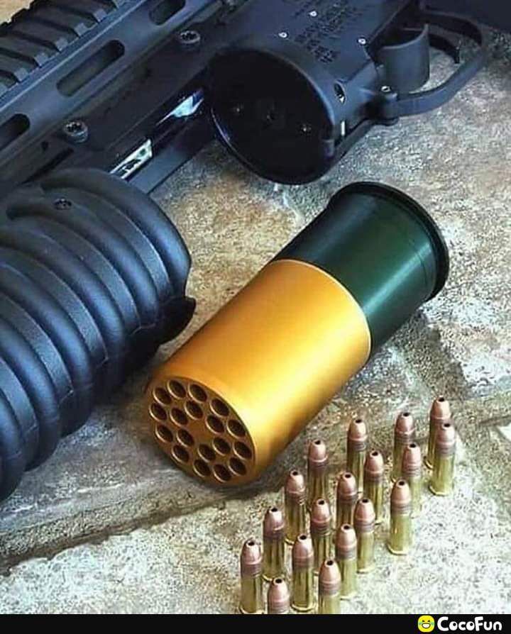 A close-up image of a grenade launcher with a multi-round projectile and several normal rifle bullets arranged in front of it.